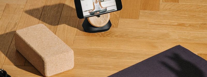 Minimalist yoga studio with warm lighting and wooden floor.